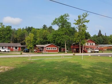 Cozy log cabins at Scott's Peaceful Valley Resort in Crane Lake, Minnesota, surrounded by pine trees near Voyageurs National Park.